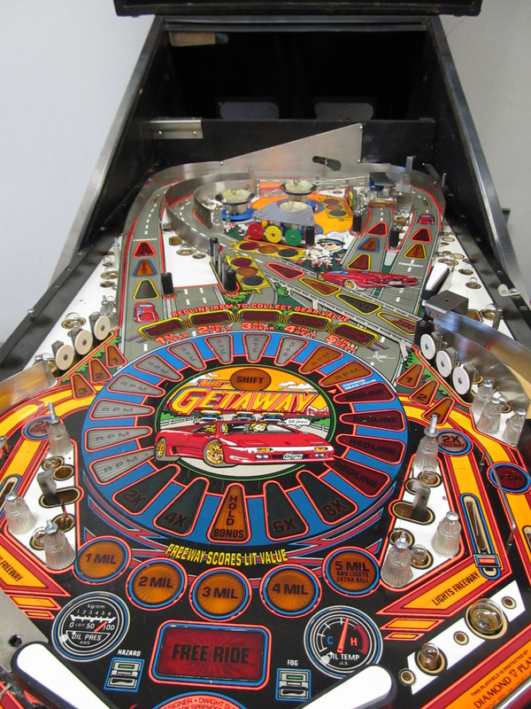 Getaway pinball machine being serviced